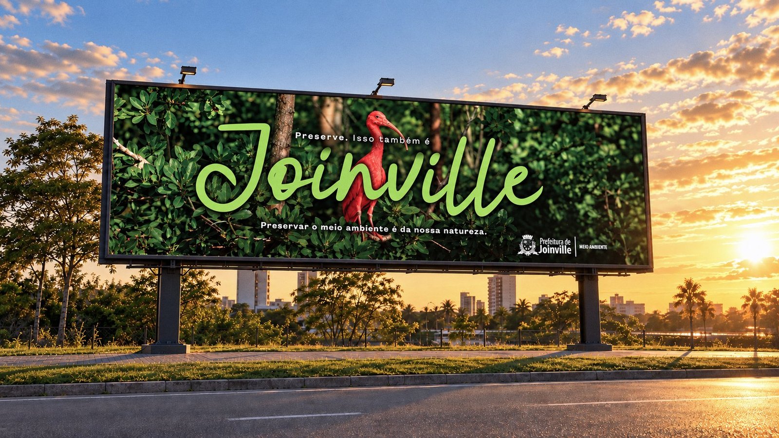 Outdoor da campanha ao pôr do sol: um guará vermelho entre a vegetação, com o nome Joinville em letra cursiva verde e a frase “Preservar o meio ambiente é da nossa natureza.”