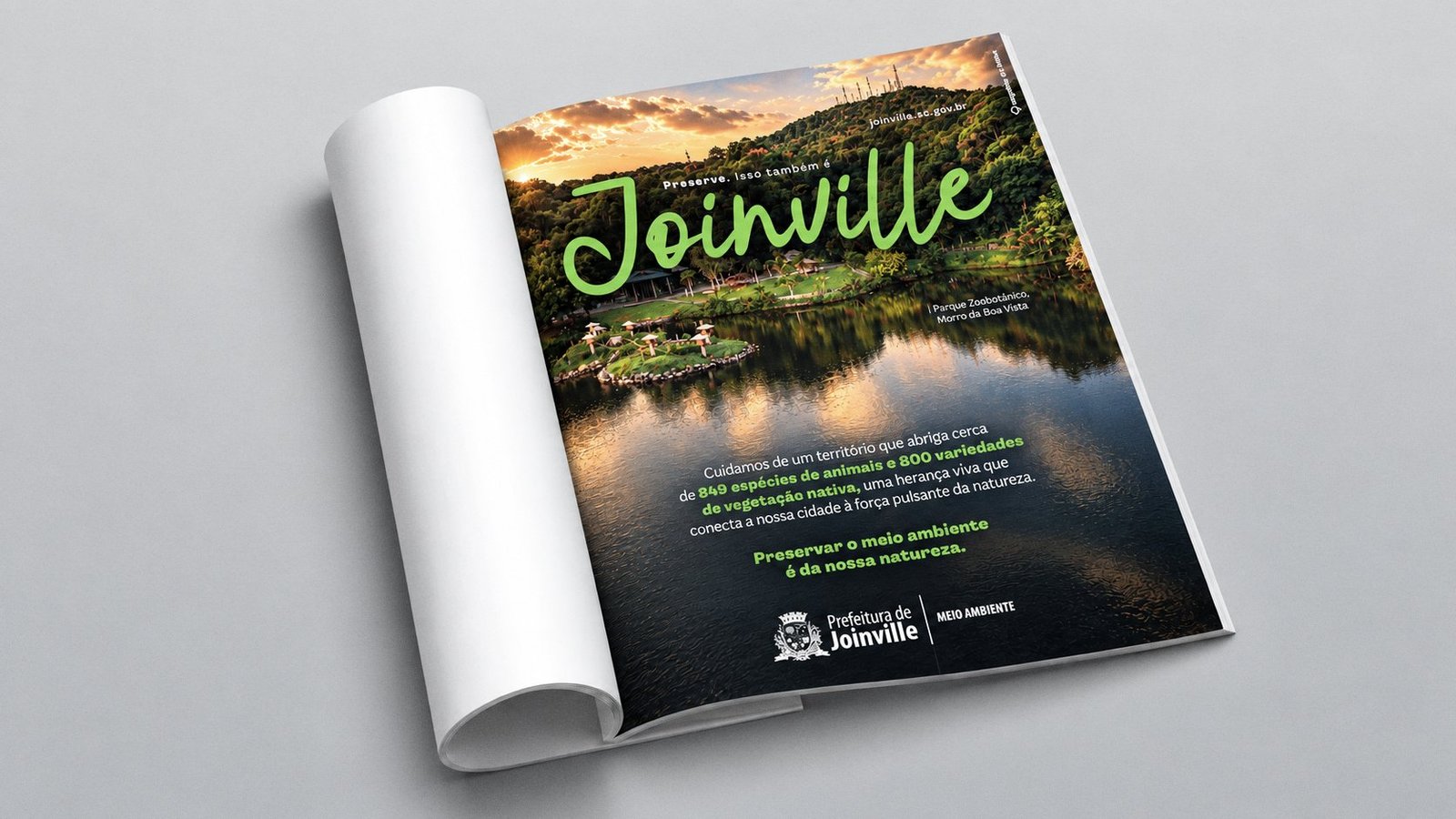 Anúncio de revista: o lago do Parque Zoobotânico, no Morro da Boa Vista, ao pôr do sol, com o título “Preserve. Isso também é Joinville” e o texto sobre as 849 espécies de animais e 800 variedades de vegetação nativa.